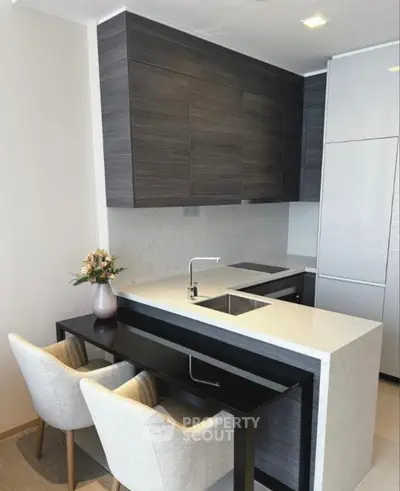 Modern kitchen with sleek cabinetry and cozy dining area