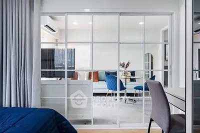 Modern open-plan living room with glass partition and stylish decor