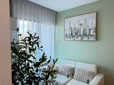 Chic living room with modern decor and cityscape artwork, perfect for urban living.