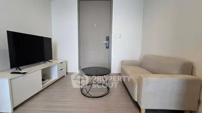 Modern living room with sleek furniture and flat-screen TV, perfect for cozy relaxation.