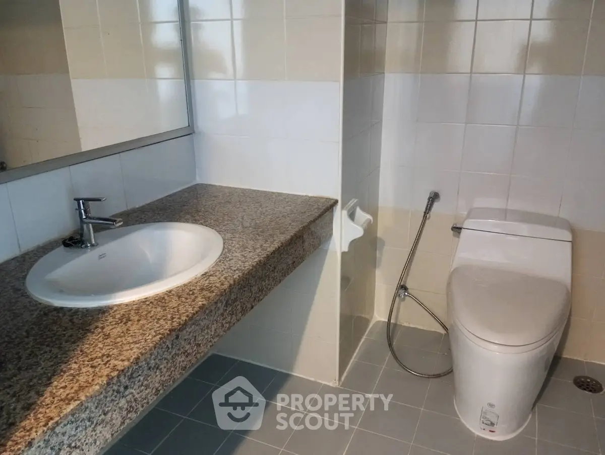 Modern bathroom with sleek fixtures and granite countertop