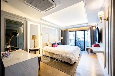 Luxurious modern bedroom with elegant decor and large window view.