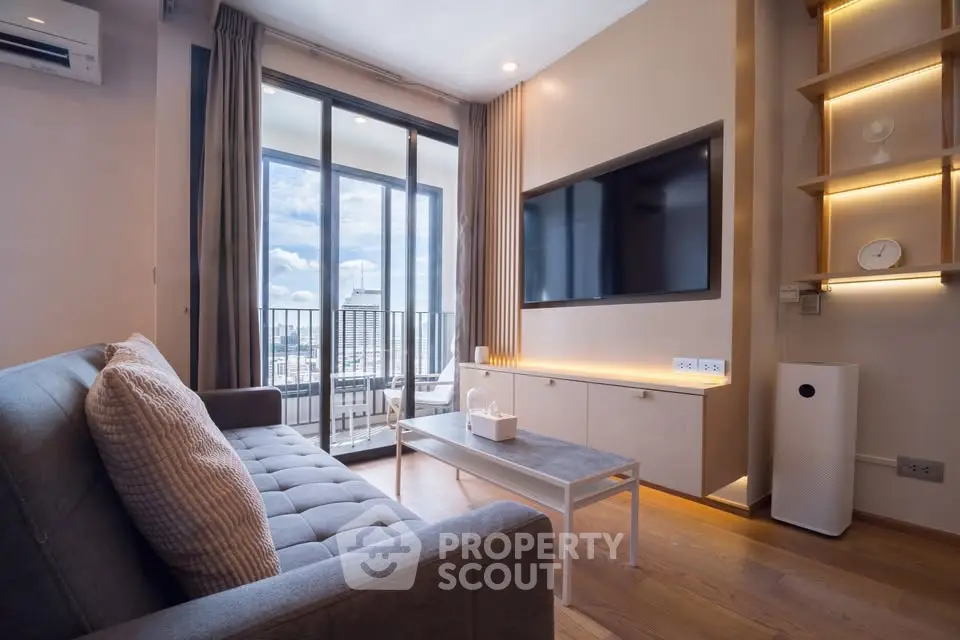 Modern living room with large windows and stylish decor in a high-rise apartment.