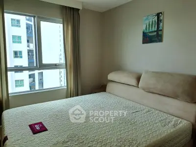 Cozy bedroom with large window and modern decor in urban apartment