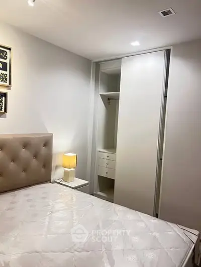 Modern bedroom with built-in closet and elegant lighting