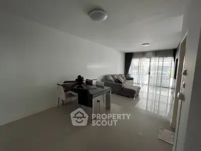 Spacious living room with modern furniture and large windows for natural light.