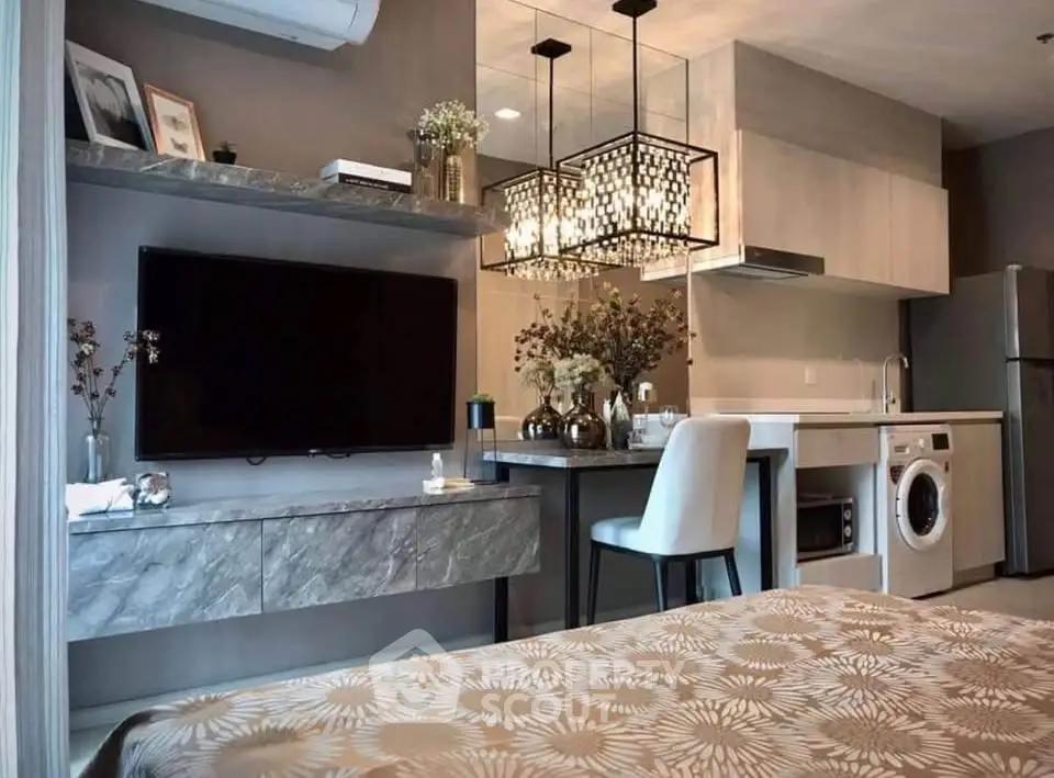 Modern studio apartment with stylish kitchen and cozy living area, featuring elegant lighting and contemporary decor.