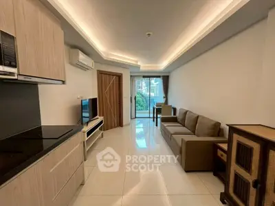 Modern living room with sleek kitchen and cozy sofa, perfect for urban living.