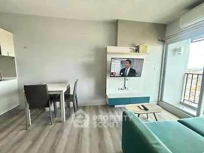Modern living room with dining area and balcony view in a stylish apartment.