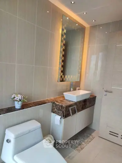 Luxurious modern bathroom with elegant fixtures and stylish lighting