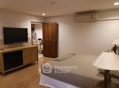 Spacious bedroom with modern furnishings and air conditioning in a cozy apartment.