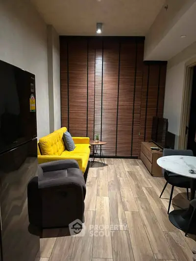 Modern living room with stylish yellow sofa and sleek wooden flooring