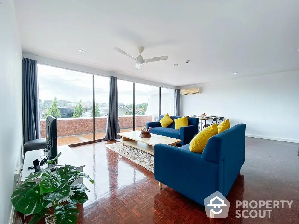 Spacious living room with modern decor and large balcony view