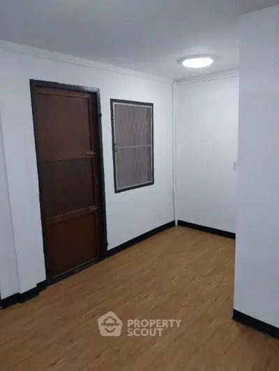 Minimalist interior with wooden flooring and simple door design