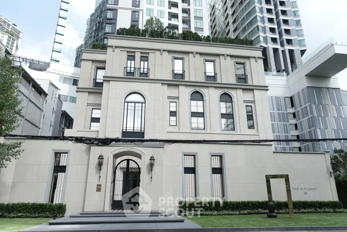 Luxurious modern building exterior with elegant architecture and lush greenery.