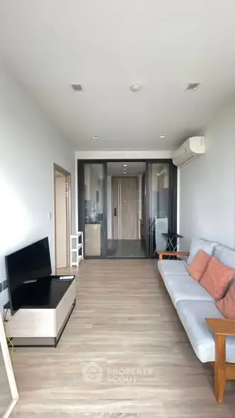 Modern living room with sleek design and comfortable seating in a stylish apartment.