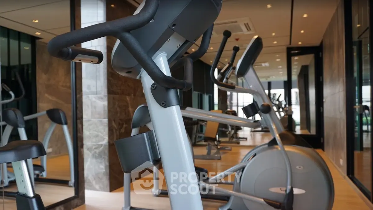 Modern gym with state-of-the-art exercise equipment and mirrored walls