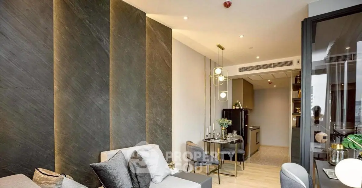 Modern living room with elegant decor and open kitchen layout in luxury apartment.