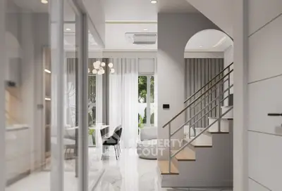 Modern open-plan living area with stylish staircase and elegant decor