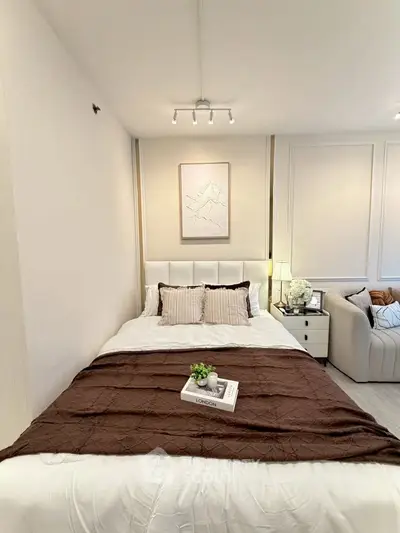 Cozy bedroom with elegant decor and plush bedding in modern apartment