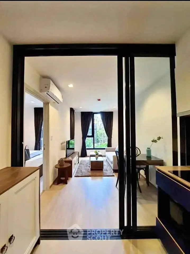 Modern living room with sliding glass doors and stylish decor in a bright apartment.