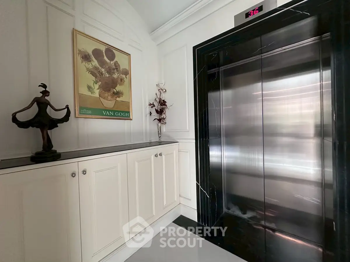 Elegant elevator lobby with stylish decor and Van Gogh artwork