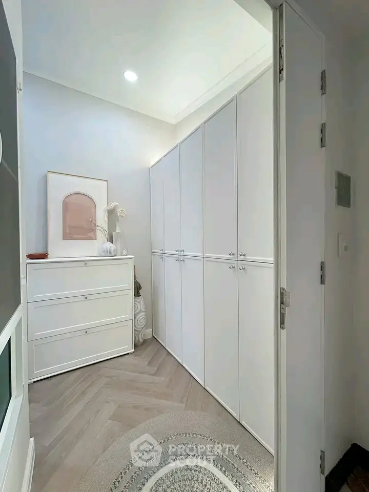 Stylish storage room with sleek white cabinets and modern decor