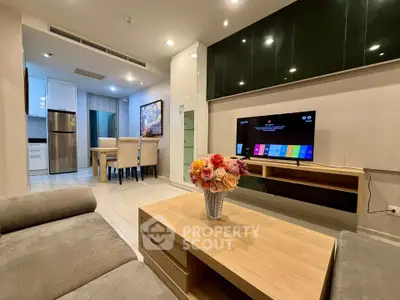 Modern living room with sleek furniture and open kitchen layout, perfect for contemporary living.