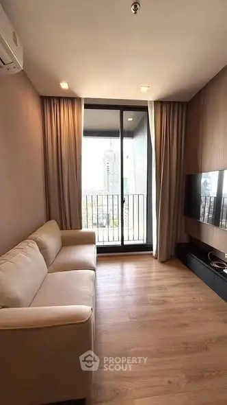 Modern living room with cozy sofa and balcony view in urban apartment