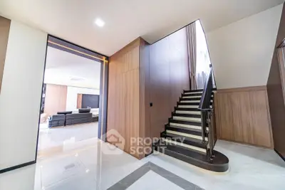 Luxurious modern interior with elegant staircase and spacious living area.