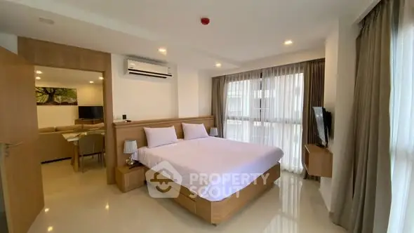 Spacious modern bedroom with natural light and elegant decor