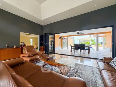 Luxurious living room with leather sofas and expansive patio view