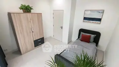 Modern bedroom with single bed, wardrobe, and stylish decor in a bright apartment.