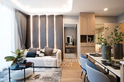 Modern living room with stylish decor and open dining area, featuring elegant furniture and natural lighting.