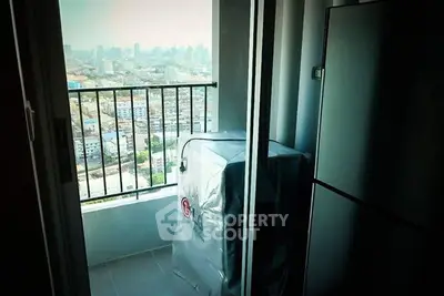 High-rise apartment balcony with city view and washing machine setup.