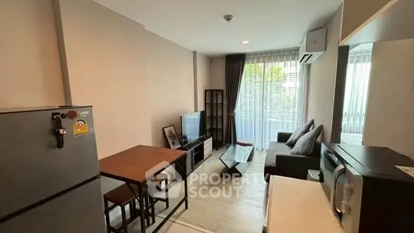 Modern living room with sleek furniture and large windows in a stylish apartment.