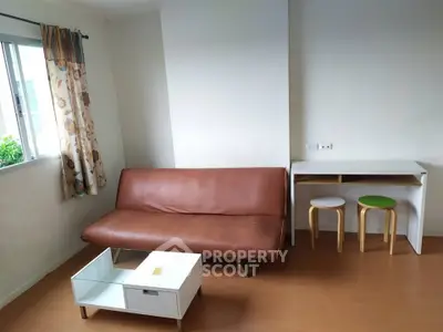 Cozy living room with brown leather sofa and modern furniture