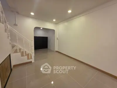Spacious interior with modern staircase and glossy tiled flooring, perfect for customization.