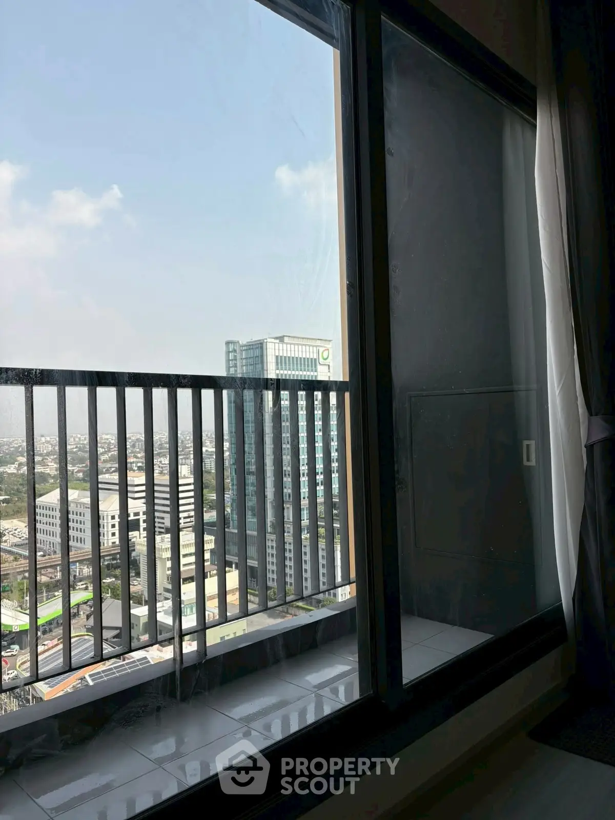 Stunning high-rise apartment view with expansive cityscape from a private balcony.