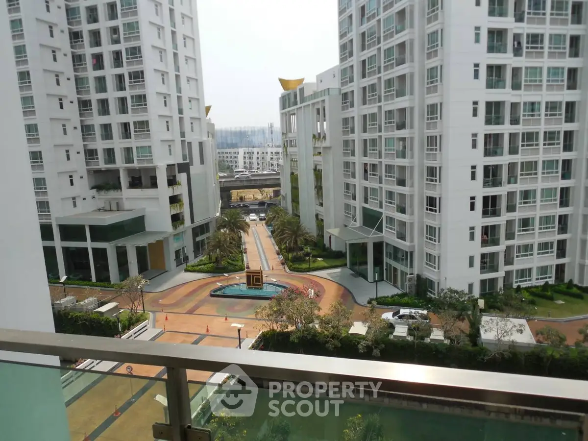 Luxurious high-rise apartment complex with stunning courtyard view and modern architecture.