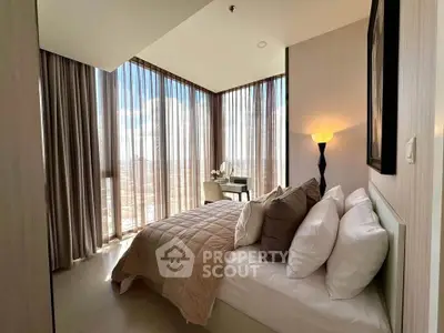 Luxurious bedroom with floor-to-ceiling windows and stunning city view