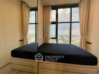 Modern bedroom with panoramic city view and large windows, featuring sleek design and natural light.