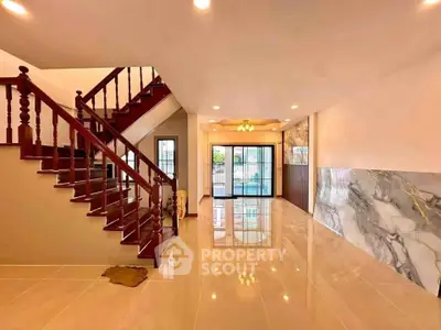 Spacious modern living room with elegant staircase and glossy tiled floors