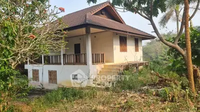 Charming rustic house with wooden accents surrounded by lush greenery, perfect for nature lovers seeking tranquility.
