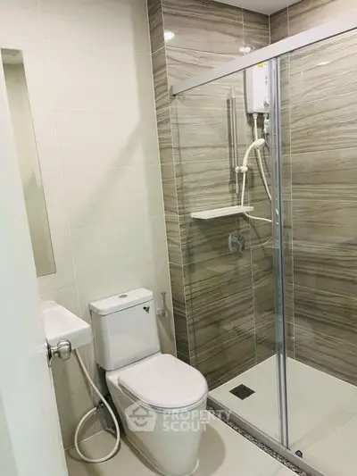 Modern bathroom with glass shower and sleek tile design