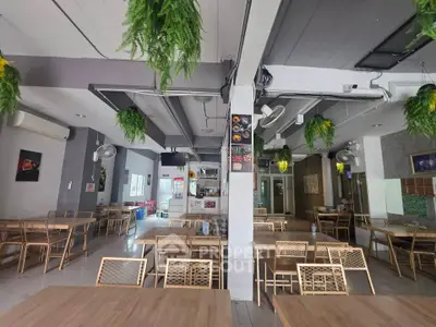 Spacious restaurant interior with modern decor and ample seating, perfect for dining and gatherings.