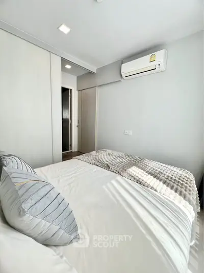 Modern bedroom with air conditioning and stylish bedding