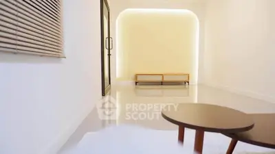 Modern minimalist living room with sleek furniture and ambient lighting