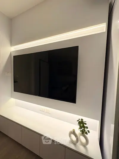 Modern living room with sleek TV setup and ambient lighting