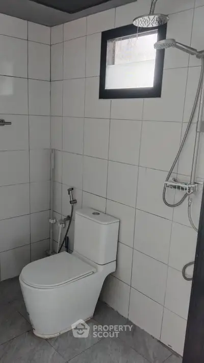 Modern bathroom with sleek white tiles and contemporary fixtures